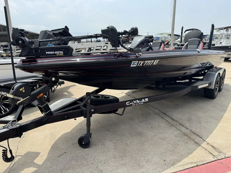 Slide: The Image of 2021 Caymas CX 20 boat on trailer, featuring Minn Kota Ultrex motor. - 4