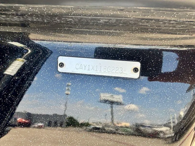 Slide: The Image of 2023 Caymas CX 21 boat with identification plate, reflecting sky and surroundings. - 4