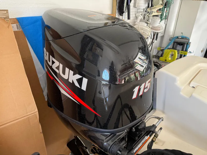 Slide: The Image of Suzuki 115 outboard motor on 2014 Bulls Bay 1700 boat in garage setting. - 10