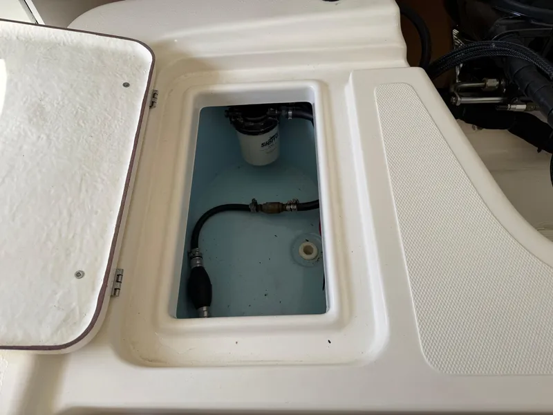 Slide: The Image of Open hatch of a 2014 Bulls Bay 1700 boat showing internal compartment and components. - 14