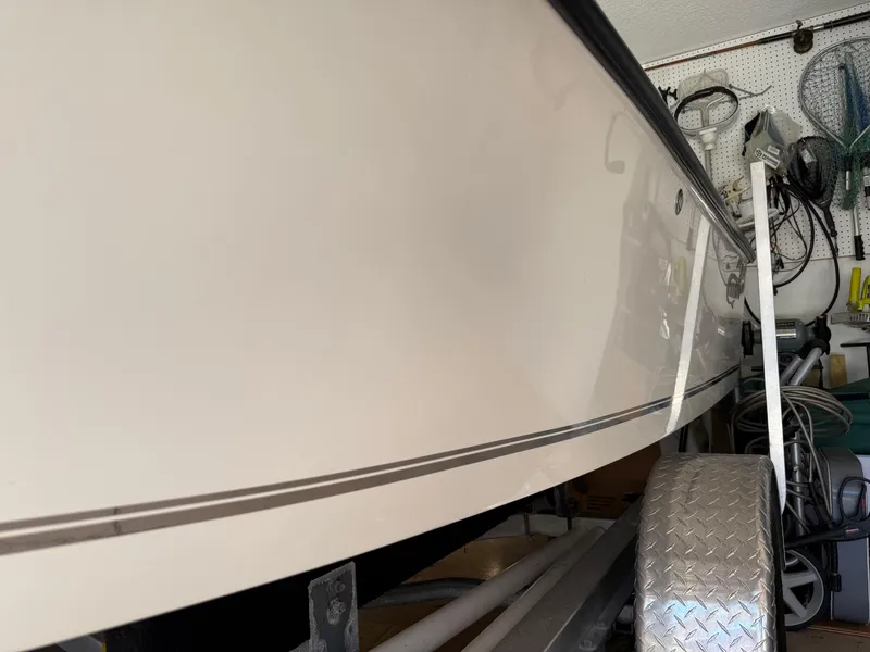 Slide: The Image of 2014 Bulls Bay 1700 boat in garage, side view with trailer. - 2