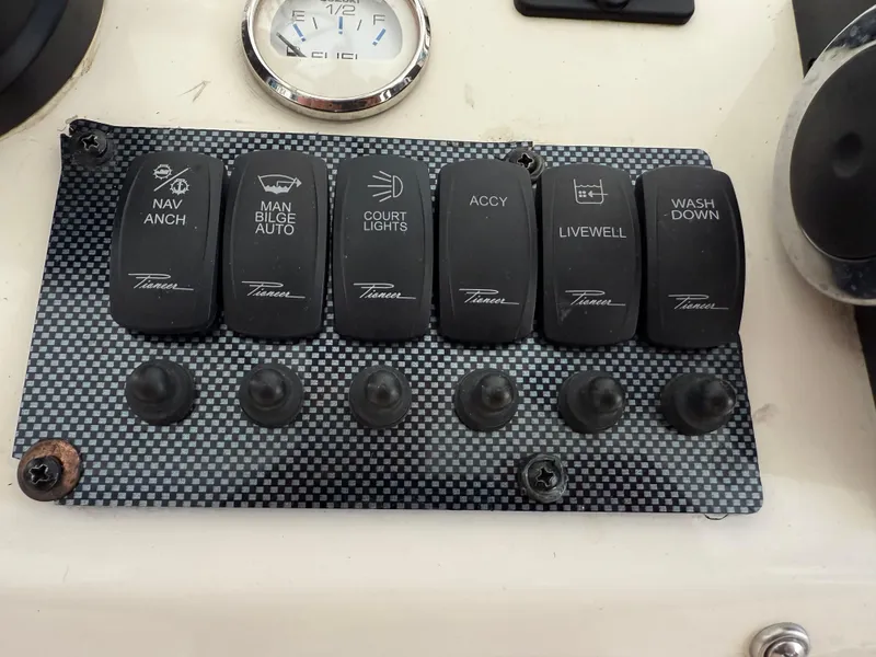 Slide: The Image of Control panel of a 2014 Bulls Bay 1700 boat with various switches and gauges. - 21