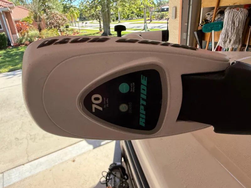 Slide: The Image of Riptide 70 trolling motor on 2014 Bulls Bay 1700 boat, parked in a sunny driveway. - 33