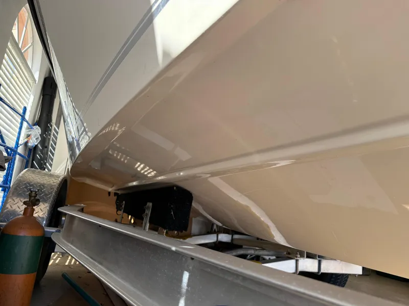 Slide: The Image of 2014 Bulls Bay 1700 boat on trailer, viewed from below in a garage setting. - 4