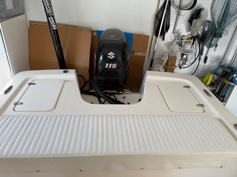 Slide: The Image of 2014 Bulls Bay 1700 boat with Suzuki 115 engine in a garage setting. - 7