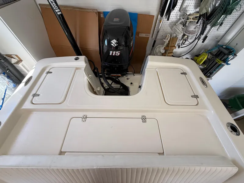 Slide: The Image of 2014 Bulls Bay 1700 boat with Suzuki 115 outboard motor in a garage setting. - 8