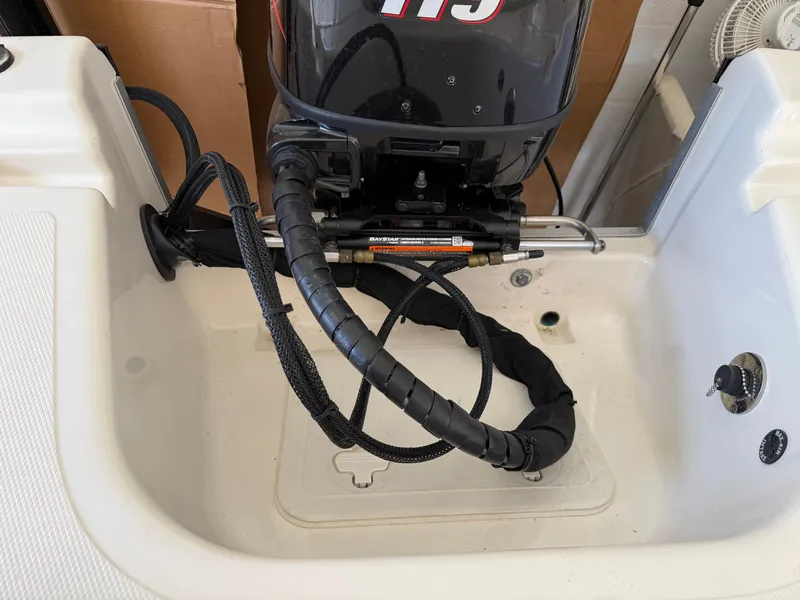 Slide: The Image of 2014 Bulls Bay 1700 boat motor and transom area with visible wiring and controls. - 9