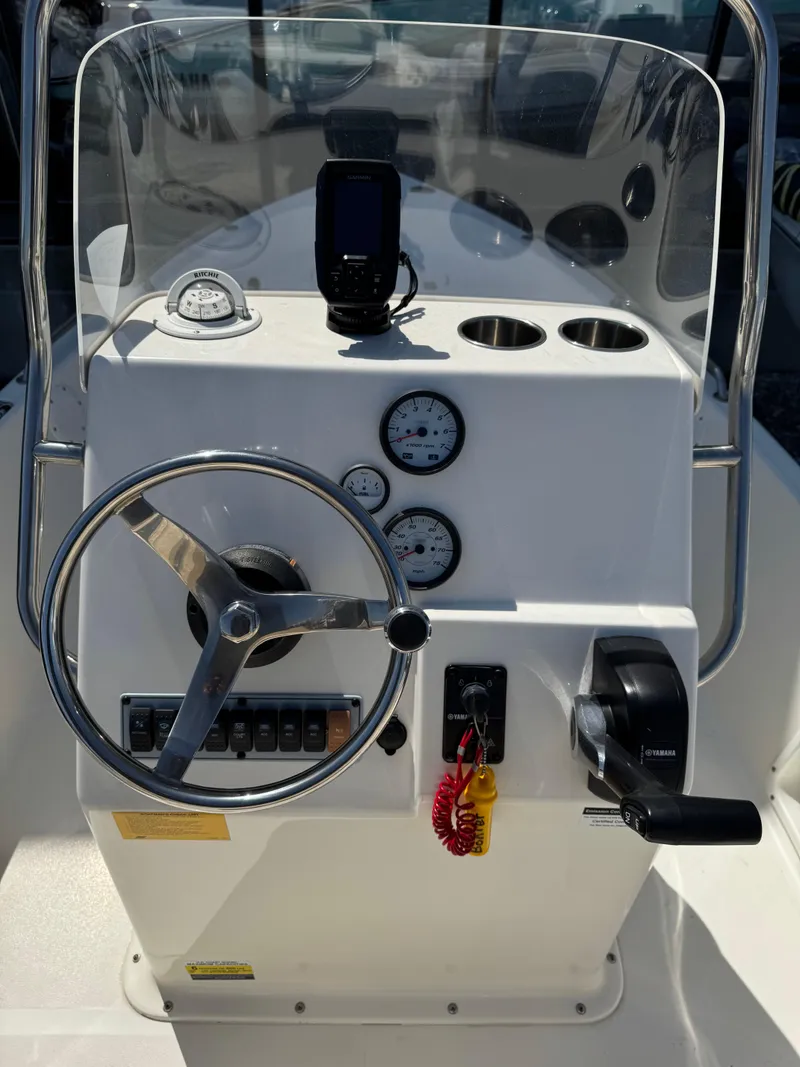 Slide: The Image of 2018 Key West 1720 Center Console boat dashboard with steering wheel and gauges. - 3