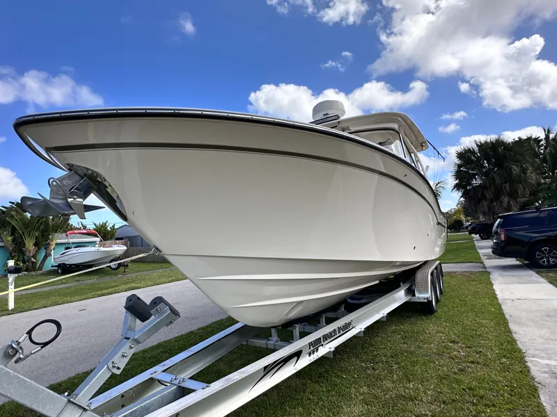 Slide: The Image of 2019 Grady-White Freedom 325 boat cruising on open water under a partly cloudy sky. - 2
