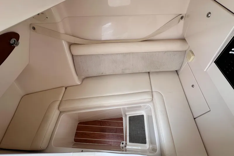 Slide: The Image of 2019 Grady-White Freedom 325 interior cabin with beige cushioned seating. - 33
