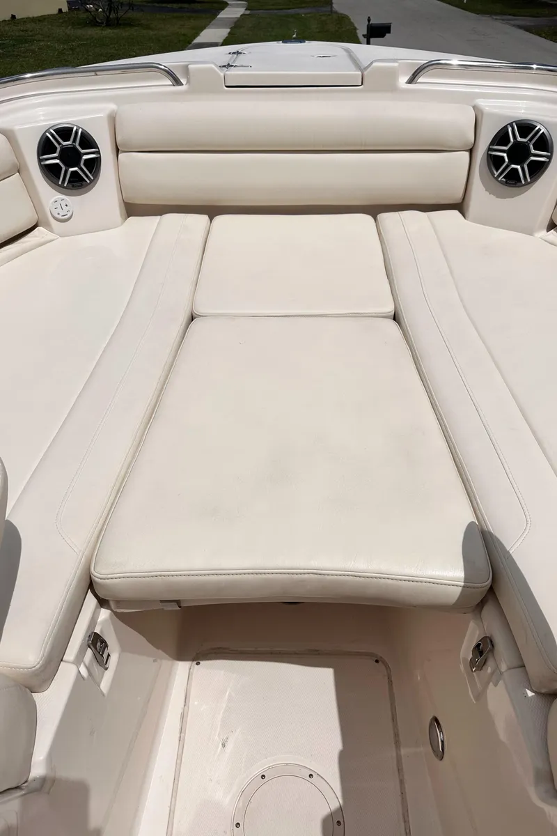 Slide: The Image of 2019 Grady-White Freedom 325 boat interior with cushioned seating and speakers. - 38