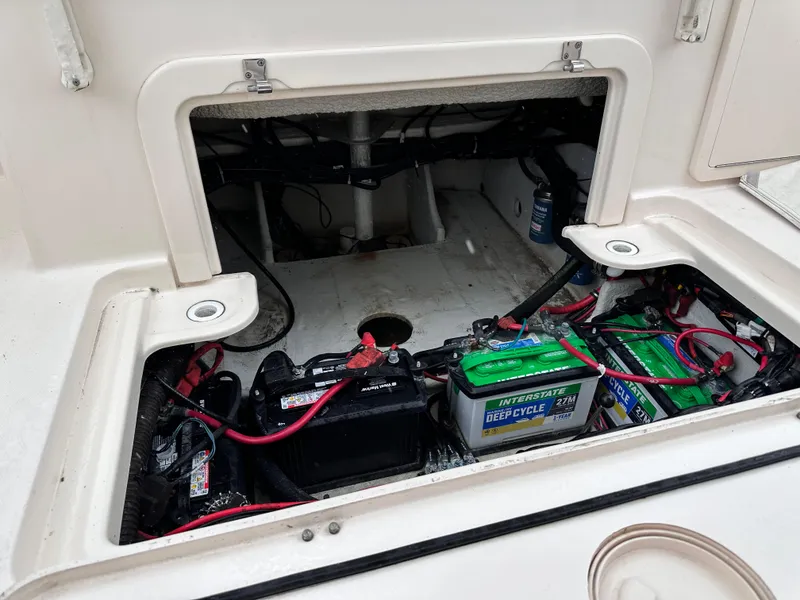 Slide: The Image of 2019 Grady-White Freedom 325 boat battery compartment with wiring and deep cycle batteries. - 44