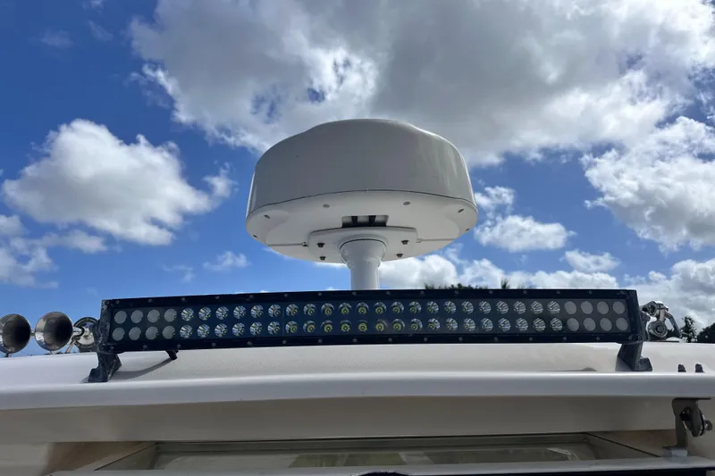 Slide: The Image of 2019 Grady-White Freedom 325 boat docked in a marina with other vessels. - 6