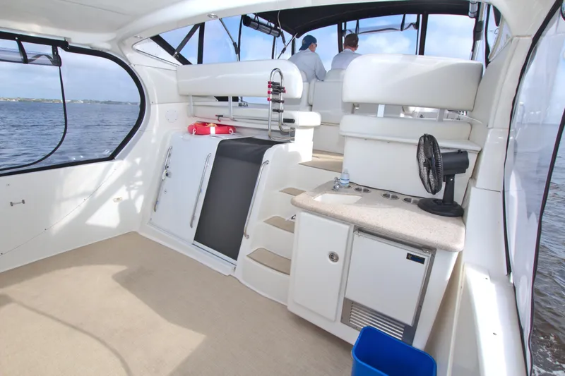 Slide: The Image of 2006 Silverton 39 Motor Yacht interior with seating, kitchenette, and water view. - 17