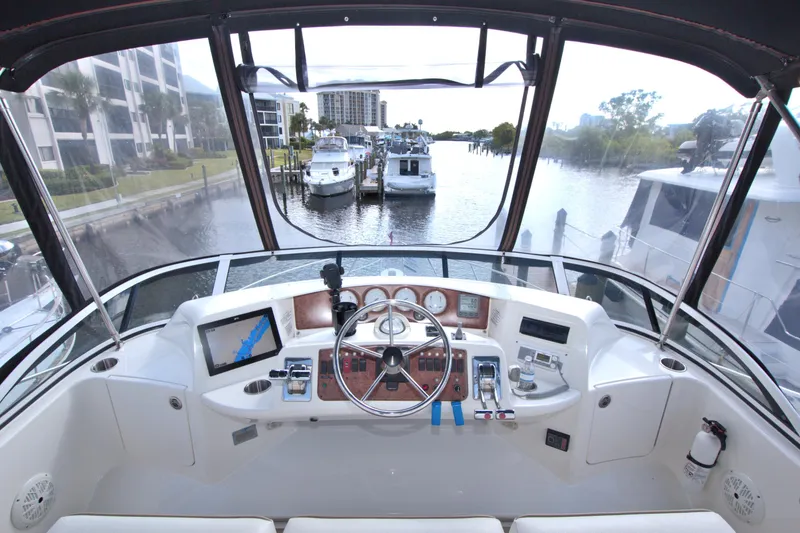 Slide: The Image of 2006 Silverton 39 Motor Yacht helm with navigation equipment, docked in a marina. - 20