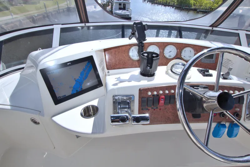 Slide: The Image of 2006 Silverton 39 Motor Yacht helm with navigation screen and controls. - 23