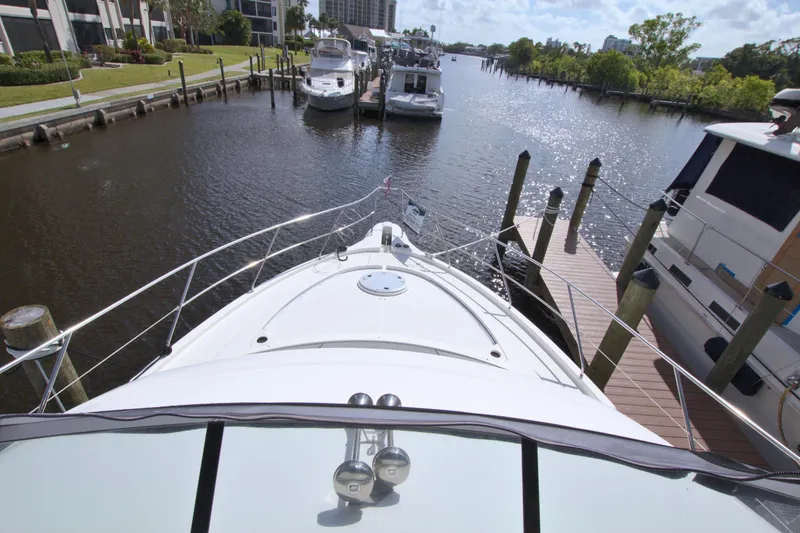 Slide: The Image of 2006 Silverton 39 Motor Yacht docked at marina, surrounded by water and other boats. - 24