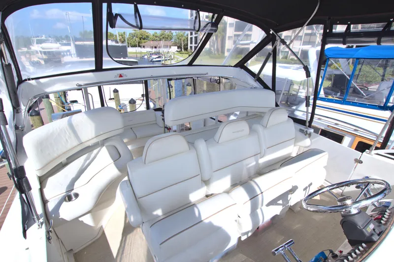 Slide: The Image of 2006 Silverton 39 Motor Yacht interior with white seating and steering wheel. - 25