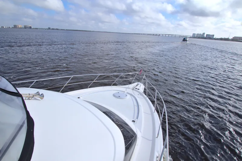 Slide: The Image of 2006 Silverton 39 Motor Yacht cruising on open water under a cloudy sky. - 27