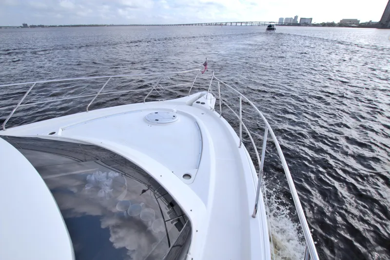 Slide: The Image of 2006 Silverton 39 Motor Yacht cruising on open water with distant bridge view. - 28