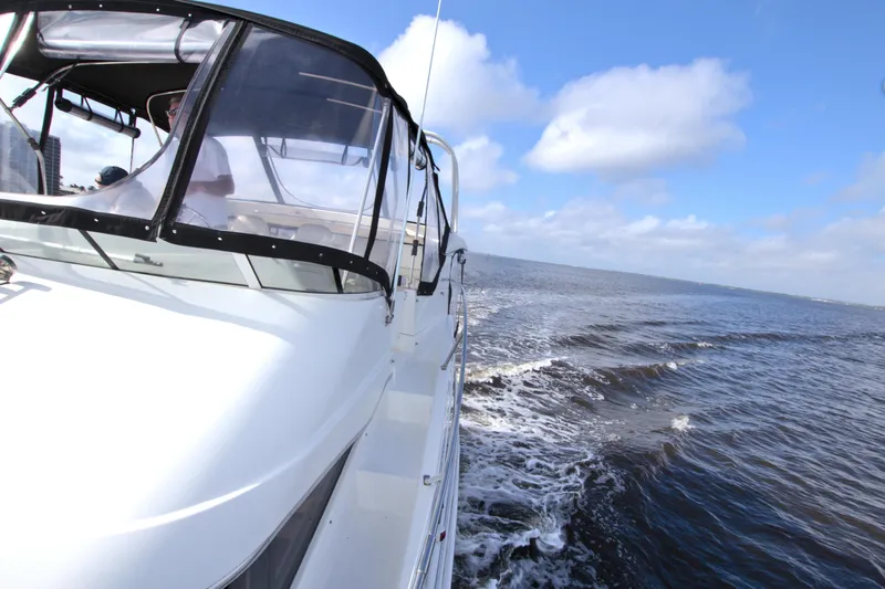 Slide: The Image of 2006 Silverton 39 Motor Yacht cruising on open water under a clear blue sky. - 32