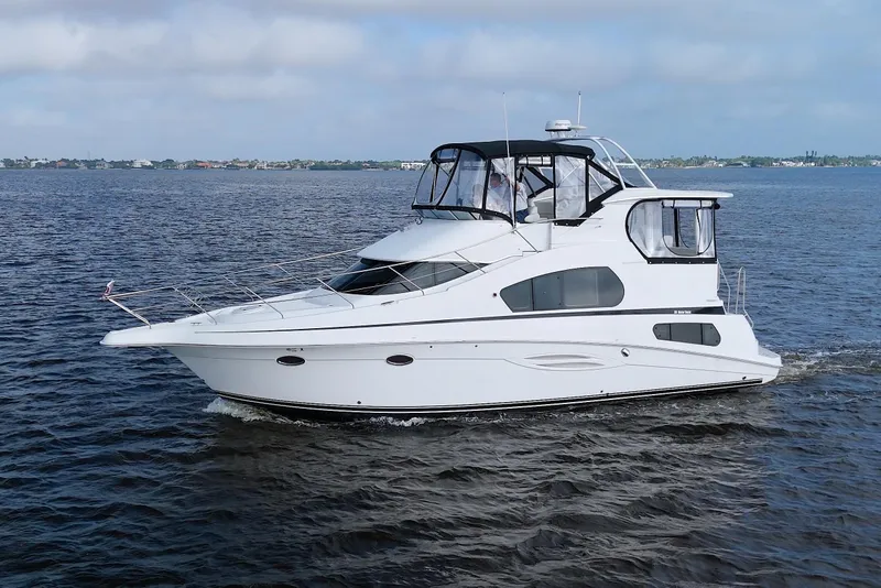 Slide: The Image of 2006 Silverton 39 Motor Yacht cruising on open water under a clear sky. - 4