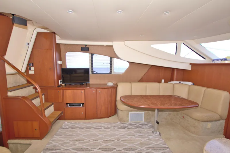 Slide: The Image of 2006 Silverton 39 Motor Yacht interior with cozy seating, wooden cabinetry, and a TV. - 40
