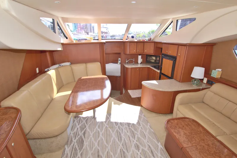 Slide: The Image of Interior of 2006 Silverton 39 Motor Yacht with beige seating and wooden cabinetry. - 43