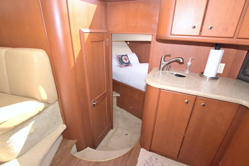 Slide: The Image of Interior of 2006 Silverton 39 Motor Yacht with cozy bedroom and kitchenette. - 46