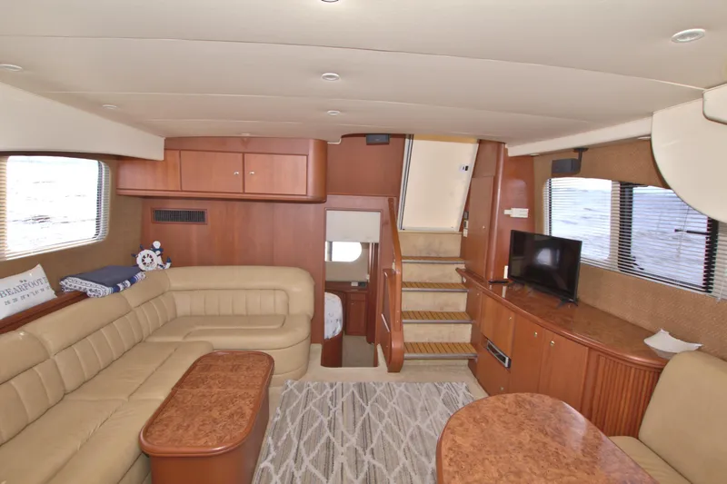 Slide: The Image of Interior of 2006 Silverton 39 Motor Yacht with beige seating and wooden cabinetry. - 56