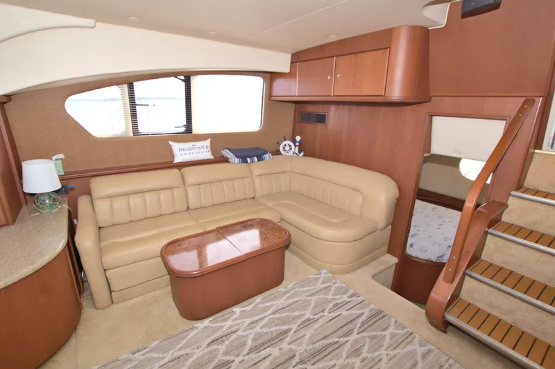 Slide: The Image of 2006 Silverton 39 Motor Yacht interior with beige leather seating and wooden accents. - 57