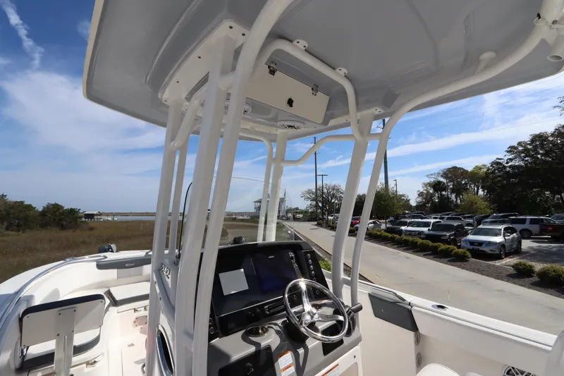 Slide: The Image of 2021 Robalo R242 Explorer boat cockpit with steering wheel and navigation system. - 11