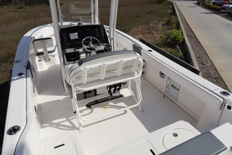 Slide: The Image of 2021 Robalo R242 Explorer boat interior with helm, seating, and storage compartments. - 14