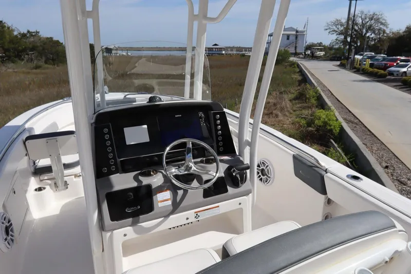 Slide: The Image of 2021 Robalo R242 Explorer boat cockpit with steering wheel and control panel. - 15