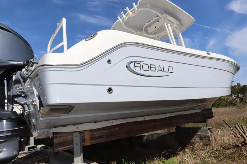 Slide: The Image of 2021 Robalo R242 Explorer boat on display, side view with clear sky background. - 3