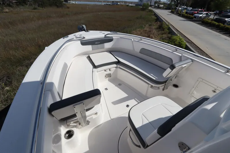 Slide: The Image of 2021 Robalo R242 Explorer boat interior with seating and storage, dockside view. - 30