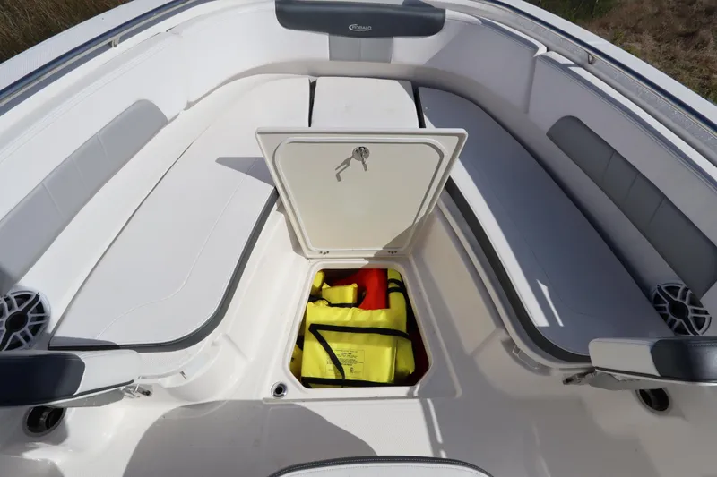 Slide: The Image of 2021 Robalo R242 Explorer boat interior with open storage compartment and seating. - 33