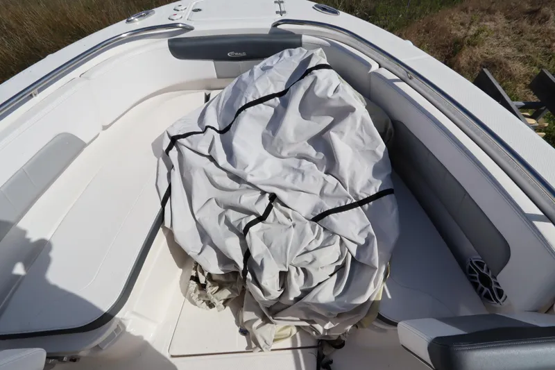 Slide: The Image of 2021 Robalo R242 Explorer boat interior with folded cover on seating area. - 34