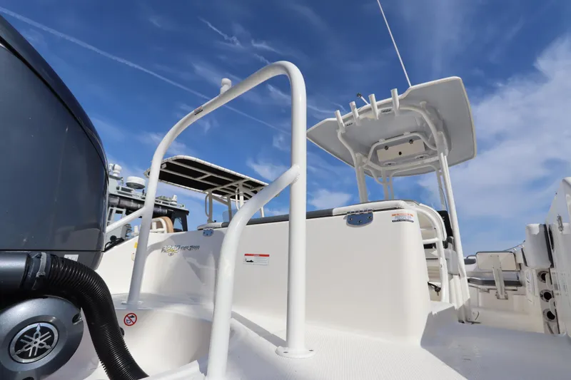 Slide: The Image of 2021 Robalo R242 Explorer boat deck with Yamaha engine, clear blue sky background. - 37