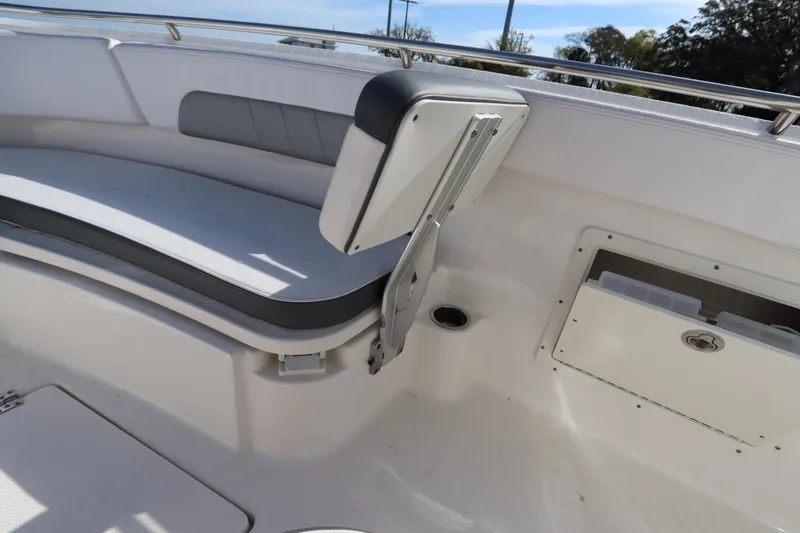 Slide: The Image of 2021 Robalo R242 Explorer boat interior with cushioned seating and storage compartment. - 38