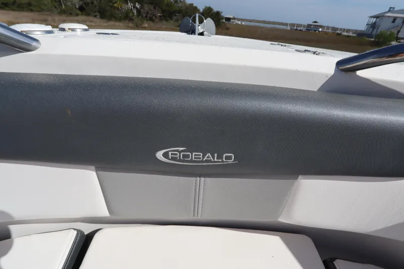 Slide: The Image of 2021 Robalo R242 Explorer boat interior with logo on cushioned seating. - 39