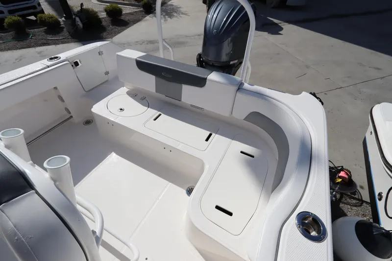 Slide: The Image of 2021 Robalo R242 Explorer boat interior with seating and storage compartments. - 40