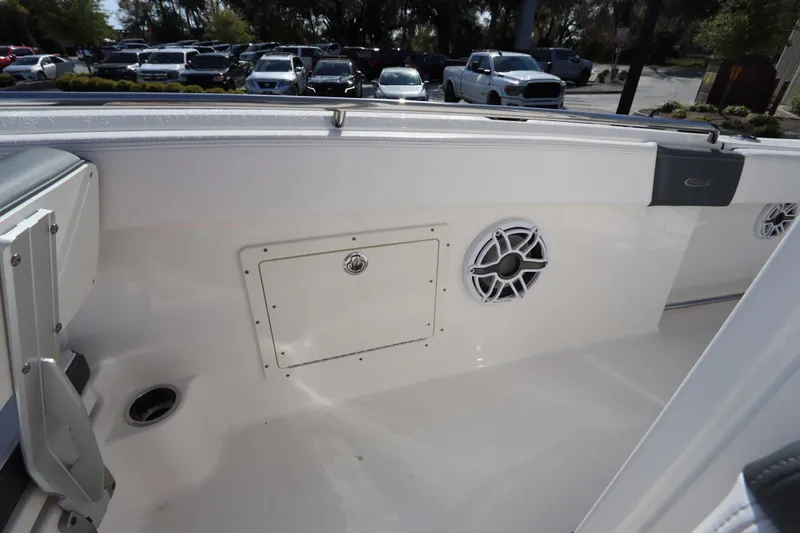 Slide: The Image of 2021 Robalo R242 Explorer boat interior with speaker and storage compartment. - 42