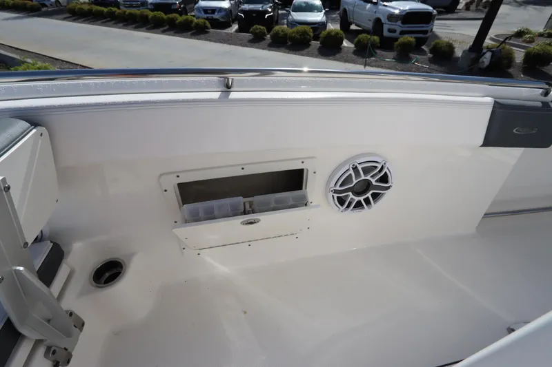 Slide: The Image of 2021 Robalo R242 Explorer boat interior with speaker and storage compartment. - 43