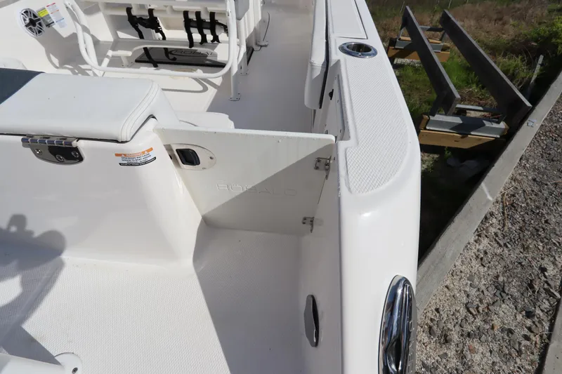 Slide: The Image of 2021 Robalo R242 Explorer boat interior, featuring seating and storage compartments. - 47