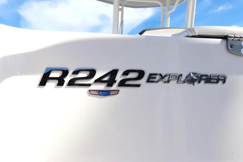 Slide: The Image of 2021 Robalo R242 Explorer boat logo on white surface under blue sky. - 7