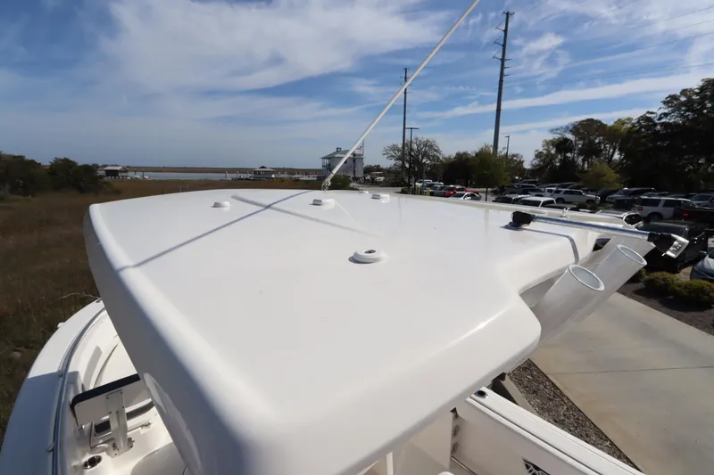 Slide: The Image of 2021 Robalo R242 Explorer boat roof with clear sky and parking lot in background. - 9