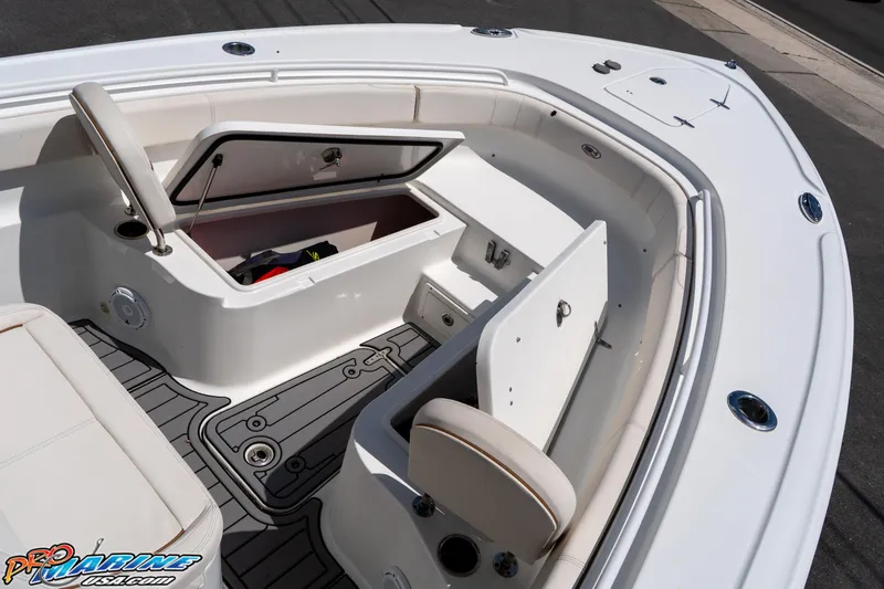 Slide: The Image of 2021 Sea Hunt ULTRA 305 boat interior with open storage compartments and seating. - 10