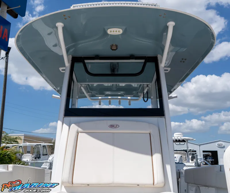Slide: The Image of 2021 Sea Hunt ULTRA 305 boat, featuring a sleek design under a clear blue sky. - 11