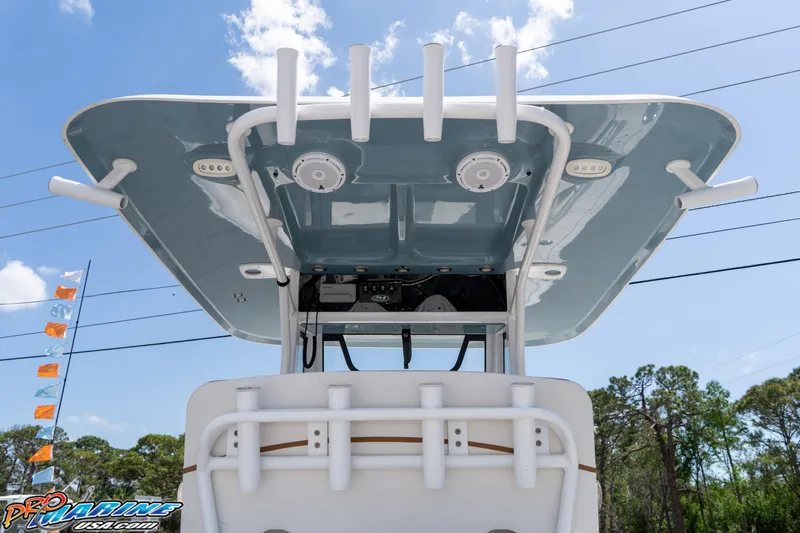 Slide: The Image of 2021 Sea Hunt ULTRA 305 boat, view of T-top and rod holders under clear sky. - 12